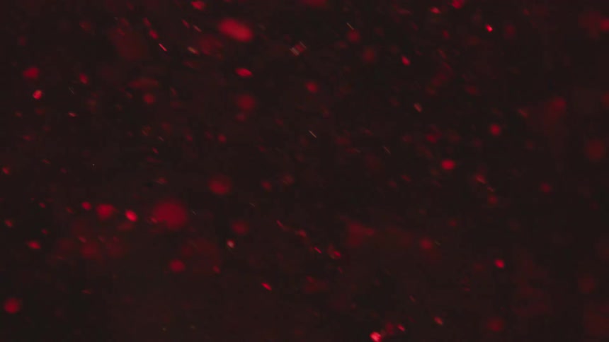 Extreme closeup of red fluid with a glowing effect in slow motion