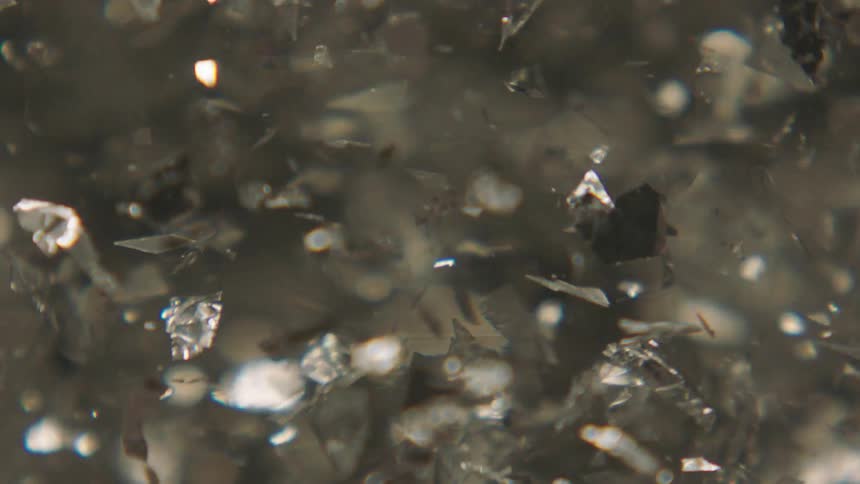Silver glitter in slow motion in the midst of water