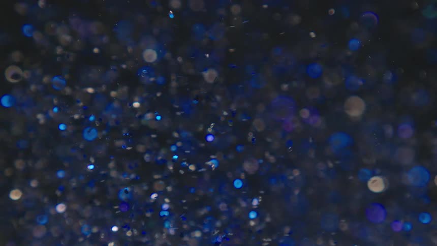 Blue particles swirling around in water