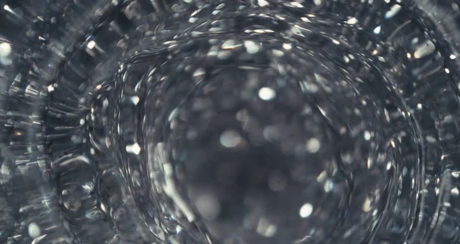 Shiny shimmering particles swirling in water