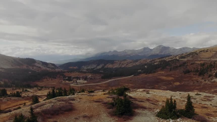 Aerial panorama of a landscape with mountains plateaus and conifers