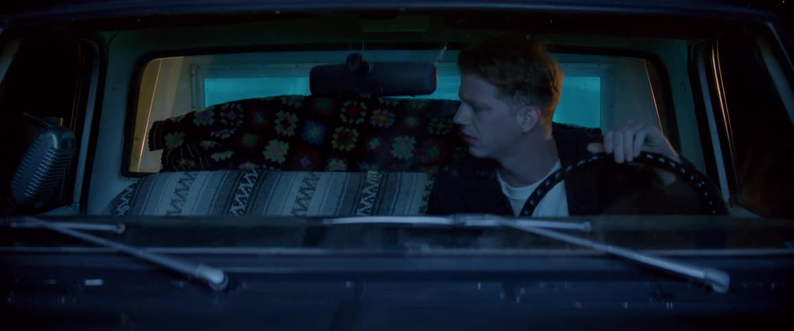 Man inside a car with a worried facial expression