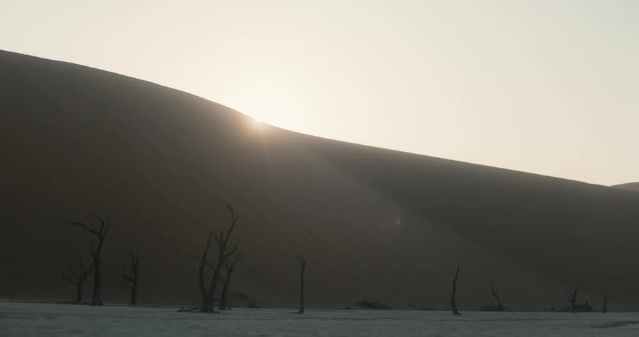 Sun sets over the sand dunes in the desert