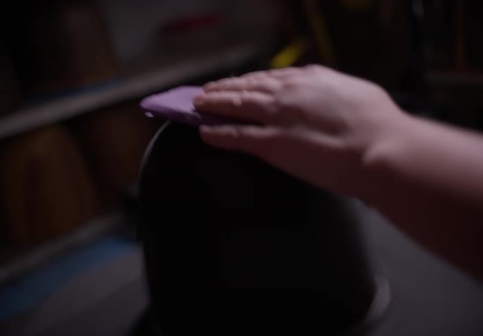 Black hat being shaped with the help of a hand