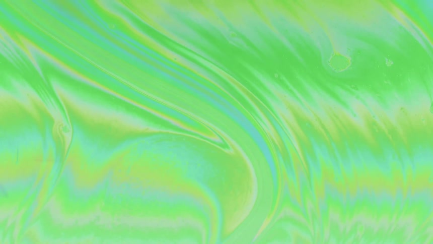 Fluid abstract and psychedelic dense substance with a greenish hue in slow motion