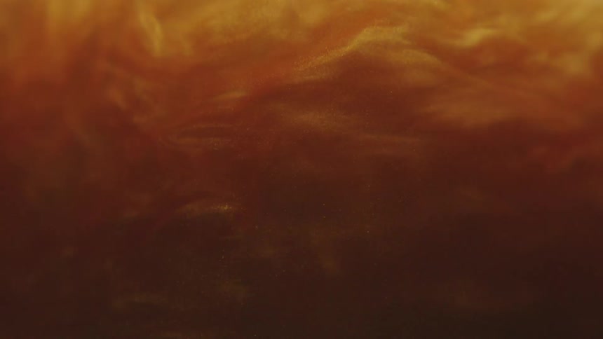 Golden abstract fluid bubbling and gently moving in slow motion