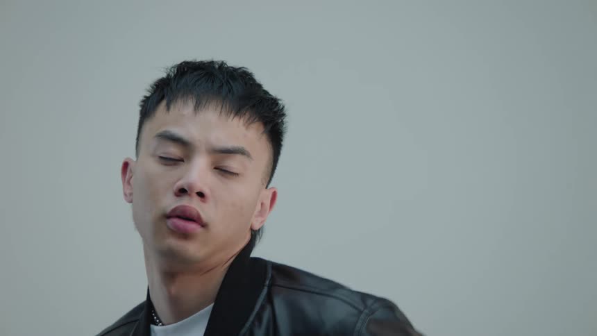 Man modeling in a white shirt and leather jacket
