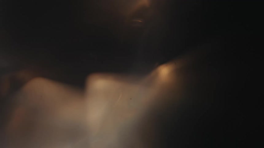 Extreme closeup of water and bubbles in motion with sunlight reflection