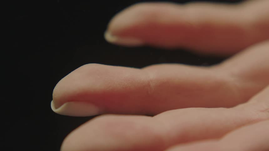 Extreme closeup of a womans white hands