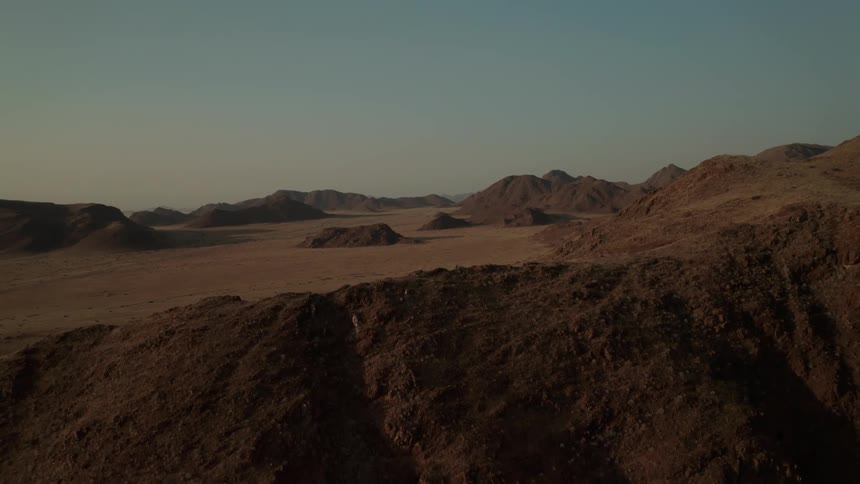 Aerial view of mountains in the desert at evening