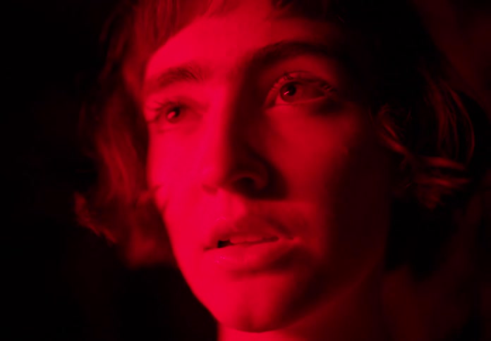 Closeup of a womans face bathed in red light