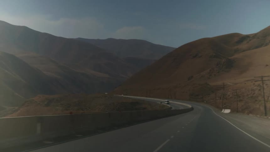Open highway through barren canyon