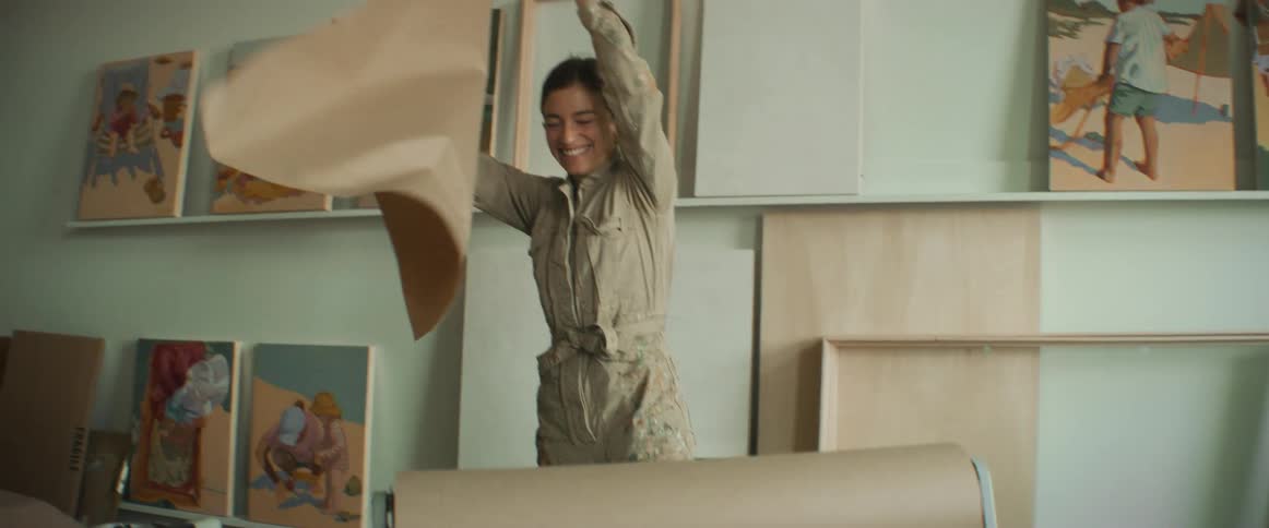 Woman unwrapping a piece of wrapping paper