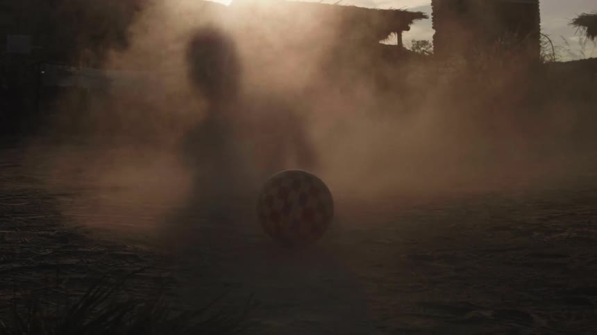 A man kicks the soccer ball