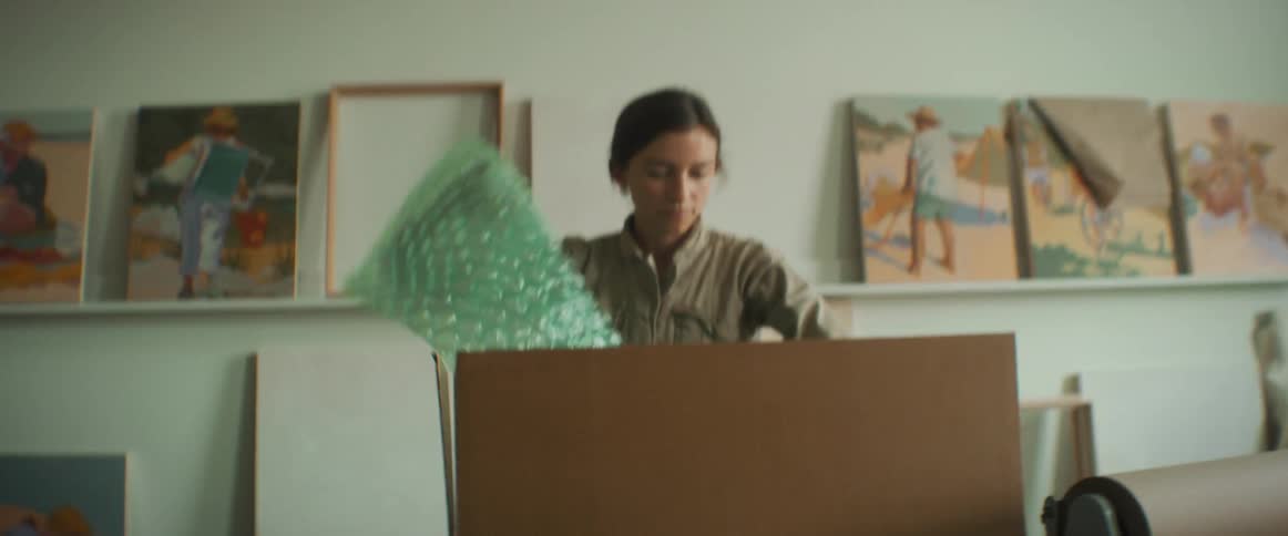 Woman placing bubble wrap inside a box