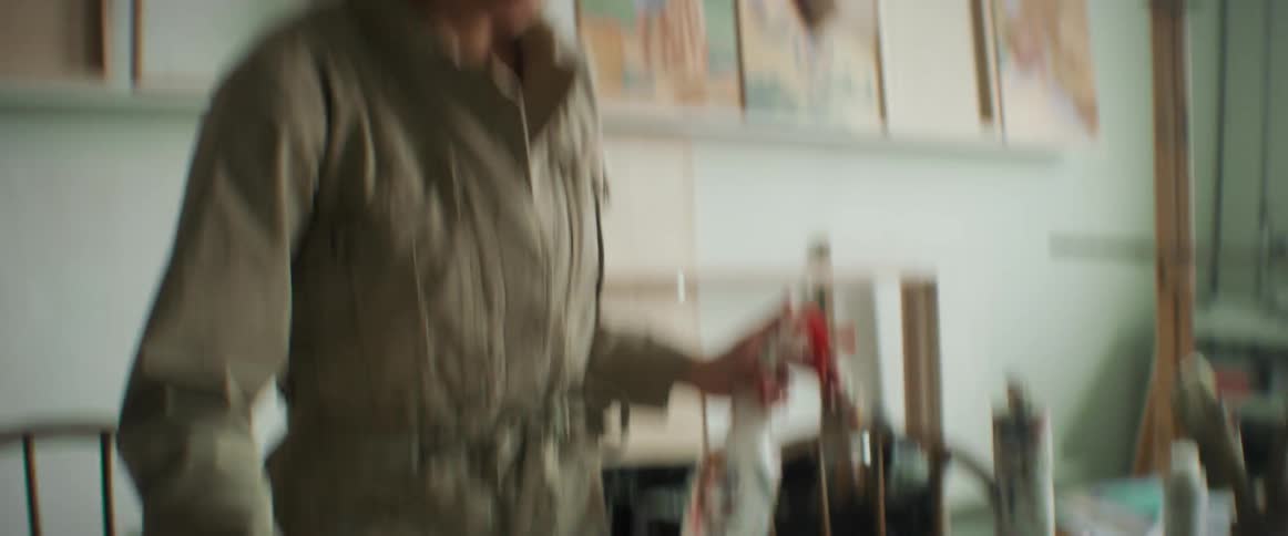 A woman painting canvas with watercolor paint