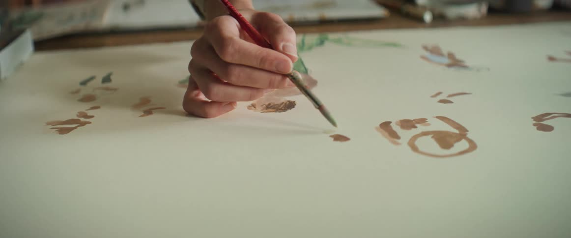 Closeup of a person painting an artistic picture