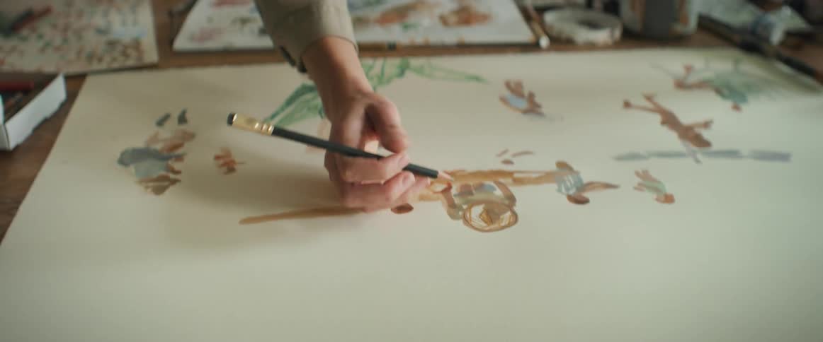 A female artist painting on a cardboard