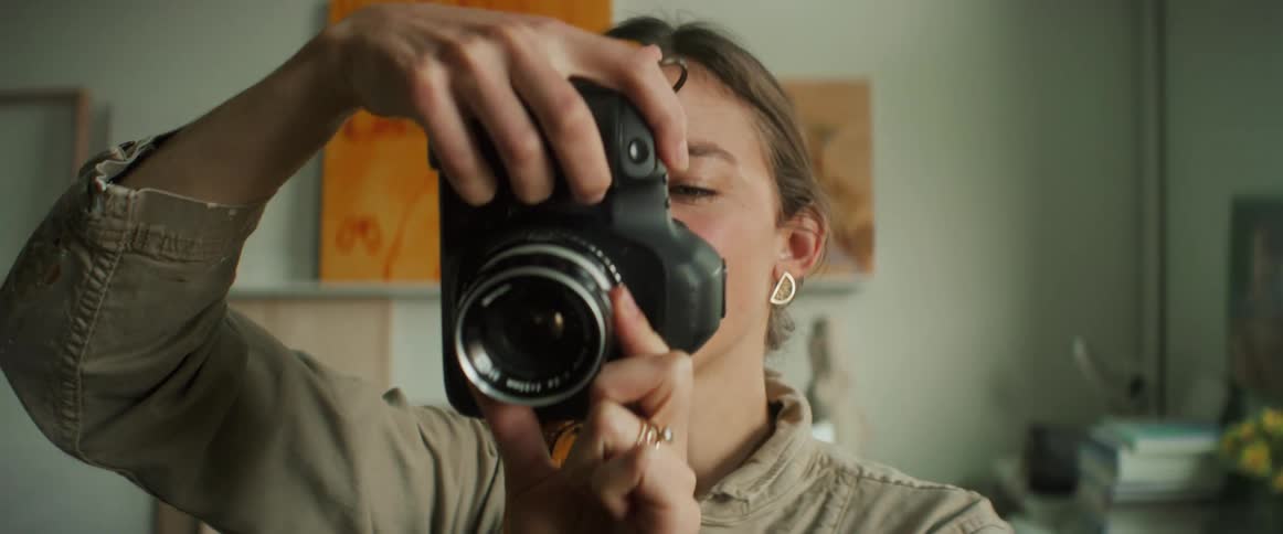 A woman with a camera photographing something