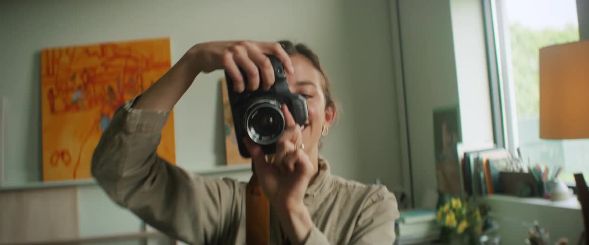 A happy woman photographing the environment