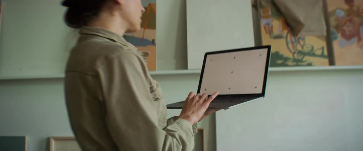 Woman standing while using a laptop