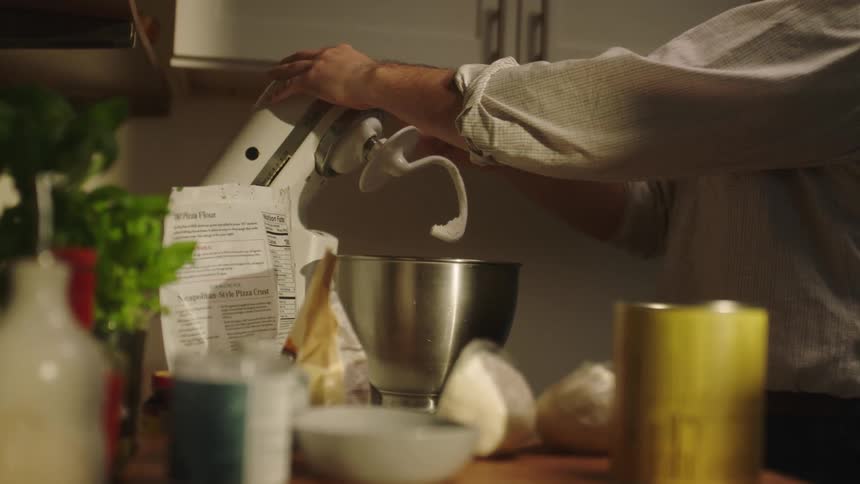 Man cooking and opening a mixer