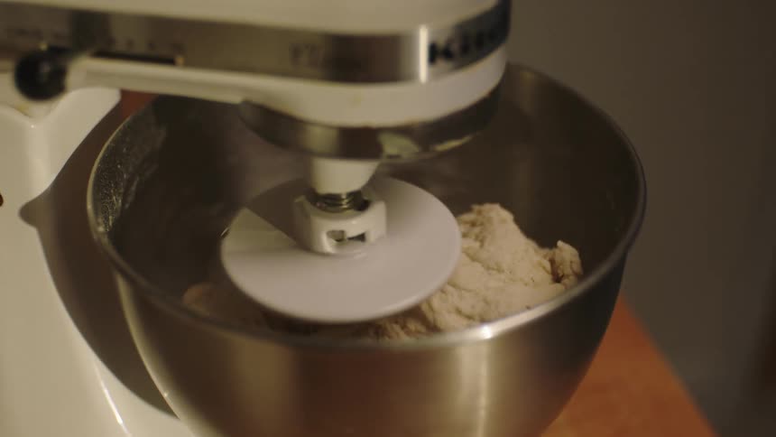 Closeup of a mixing machine kneading dough