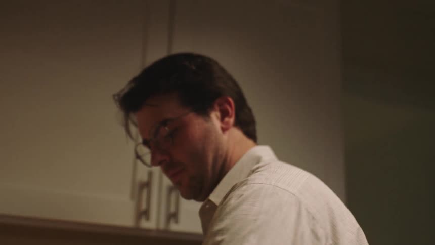 Man kneading doug in the kitchen at home