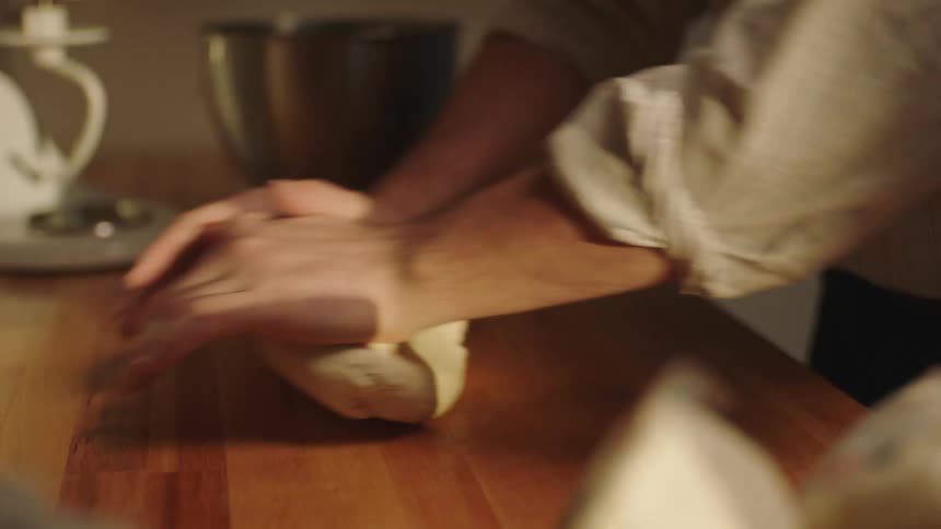 Closeup of a persons hands kneading dough
