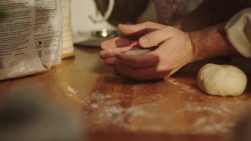 A person in the kitchen preparing to bake bread