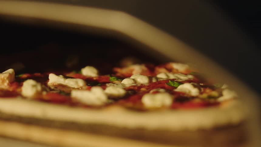 A pizza baking in the oven