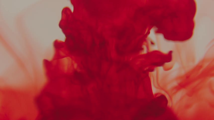 The red ink flows in the water