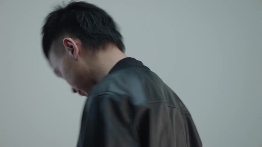 Young man modeling a black leather jacket