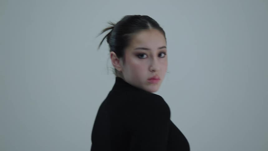 Woman wearing a black sweater poses for the camera