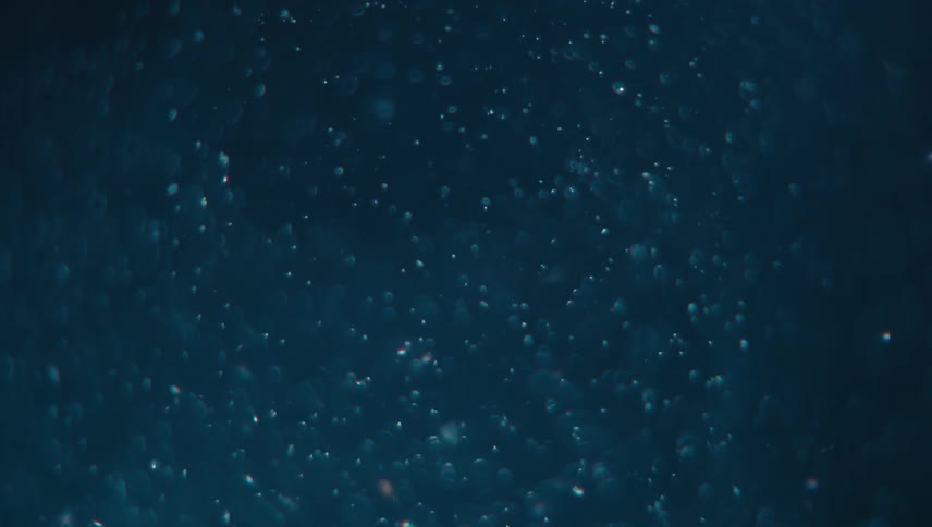 Abstract particles move across dark blue background