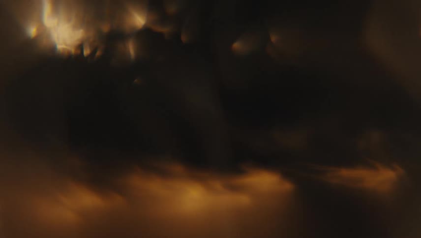 Close up of light shining on a vortex of swirling clear water