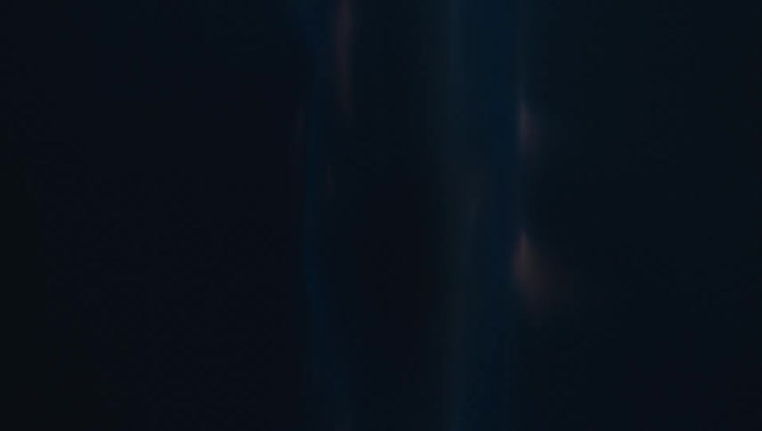 Blue flame flickers against black background