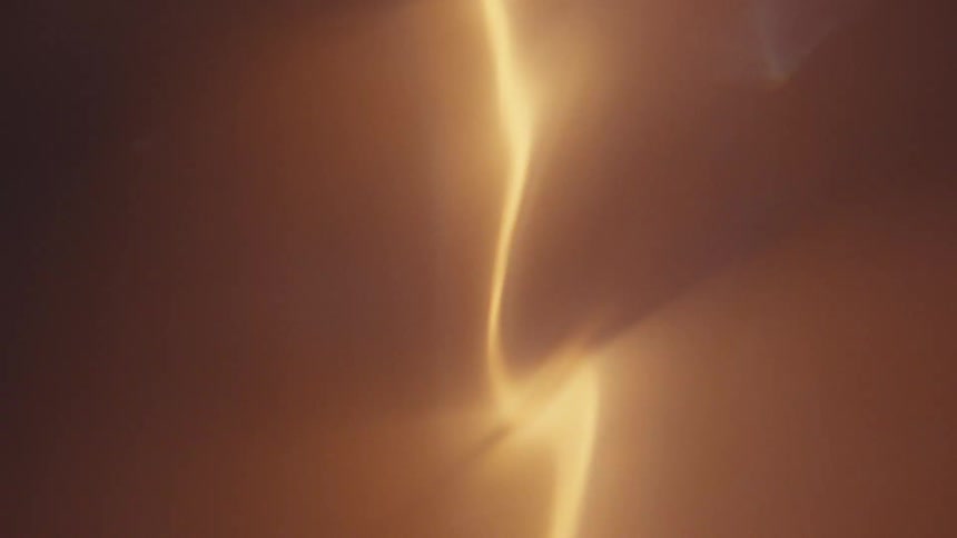 Close up of swirling column of light reflecting on water
