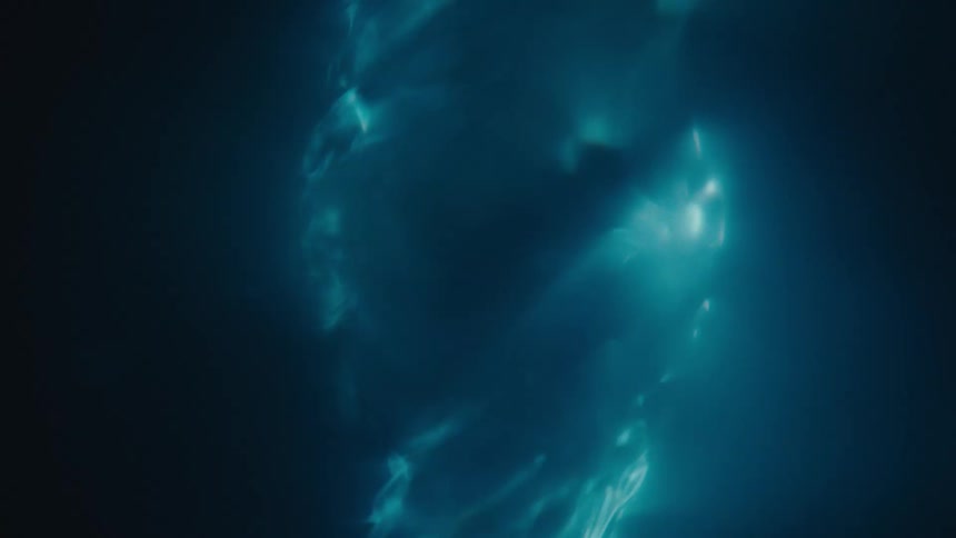 A liquid with a bright blue light is spinning