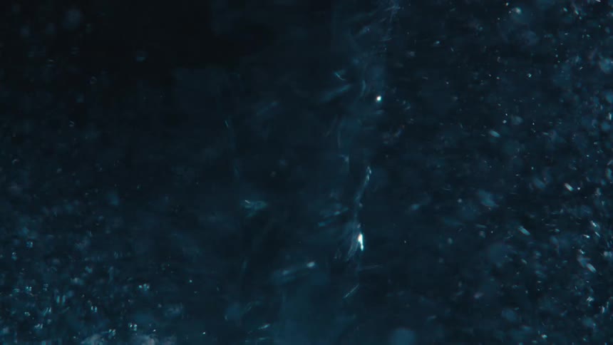 Close up of swirling clear water against a black background