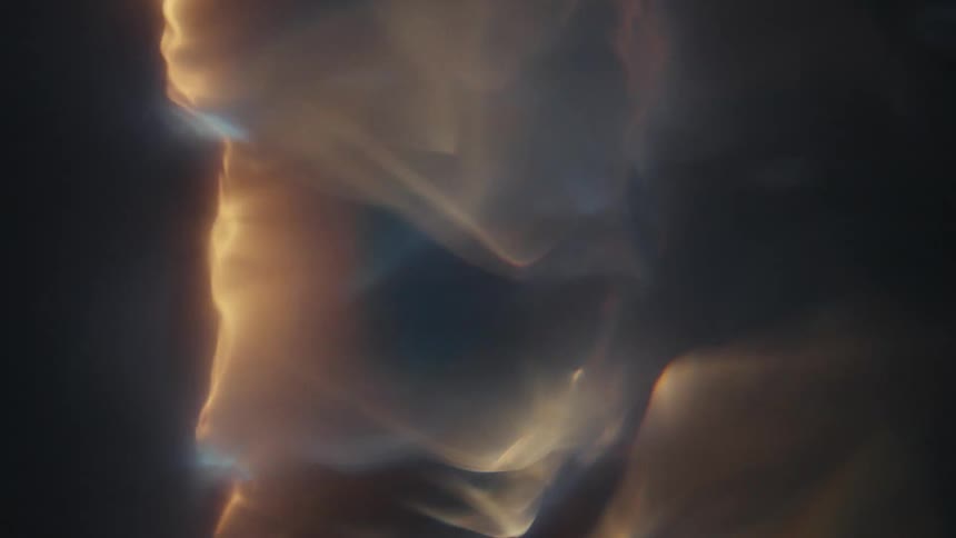 A shiny liquidlooking object is spinning rapidly