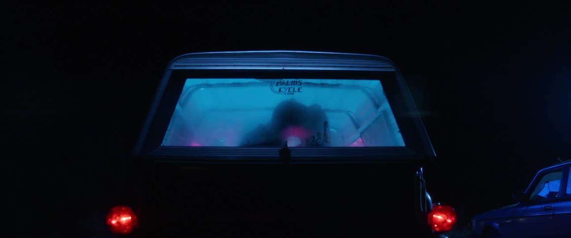 Couple kissing in the car at night with the windows fogged up