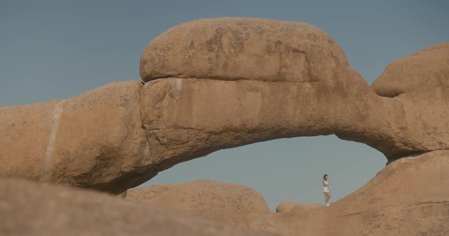Woman walking among geological and natural rocks