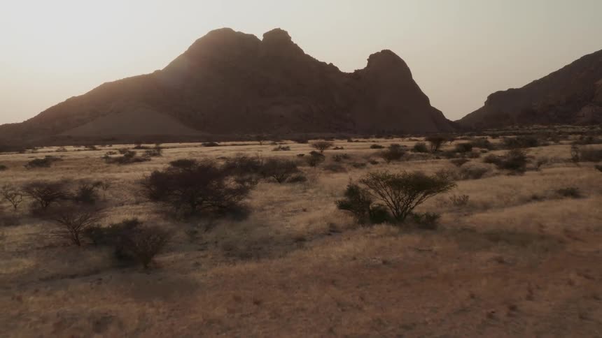 Sun sets over the mountains in the savanna