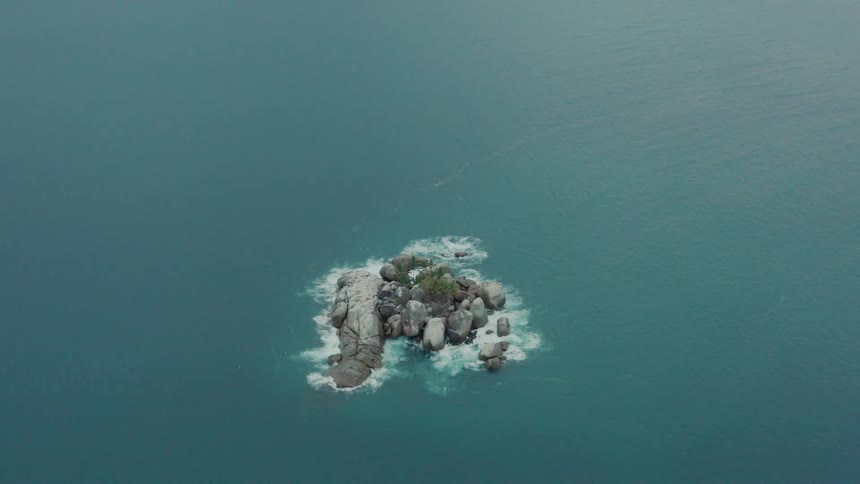 Aerial view of a small rocky island in the ocean