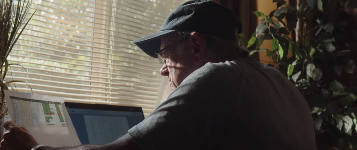 An elderly man working on a computer