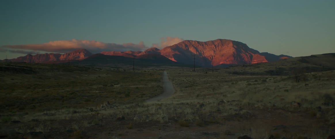 The flat land leads to a mountain range