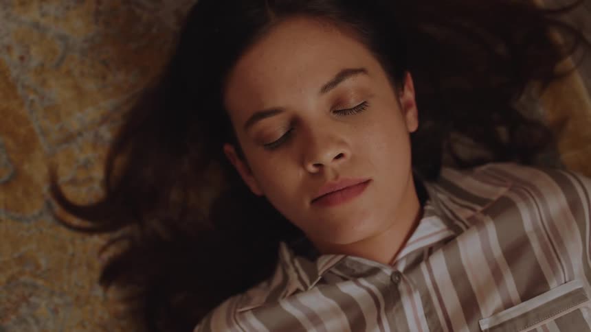 A woman is laying down sleeping