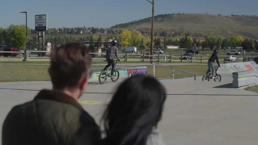 Teenagers are riding their bikes in the park