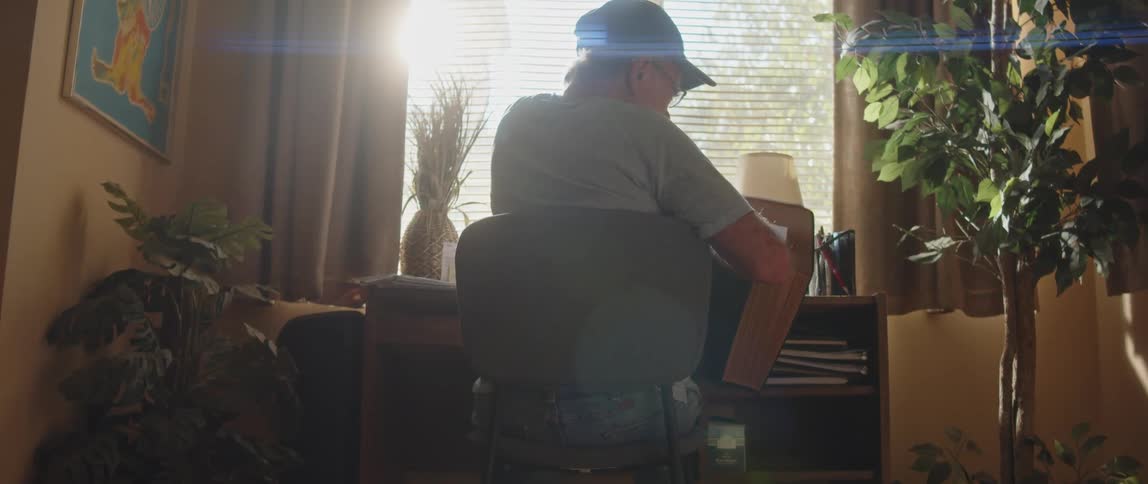 A man pulls paper out of a folder